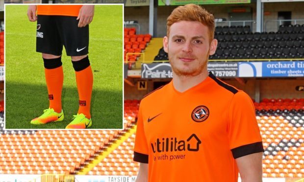 Fraser Fyvie, who has signed a new deal with the club, models next season's home strip — complete with black shorts.