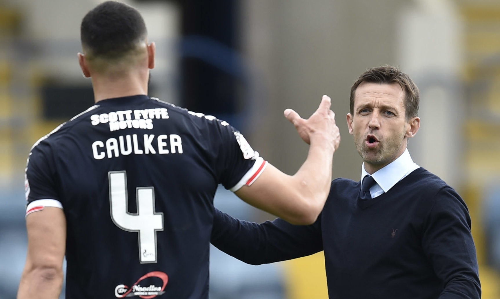 Steven Caulker with manager Neil McCann at Dundee. Image: SNS.