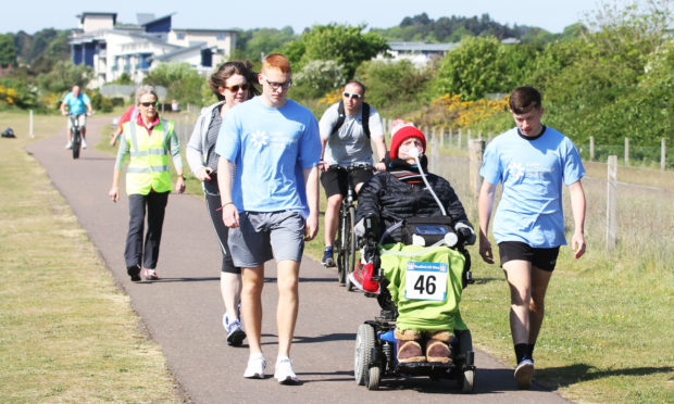 Donald Grewar taking part in the 10k with school captains Jacob Dempster and Ryan Docherty.