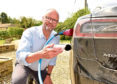 Actor Robert Llewellyn uses his smart meter on his electric car to measure his electricity usage