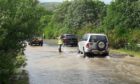Motorists struggling on the flooded A823 on Monday evening.
