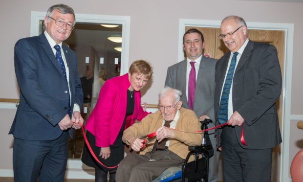 Councilors David Alexander, Judy Hamilton, David Graham and David Ross help Lindsay Houses oldest resident, 99-year-old James Oliver, with the opening ceremony