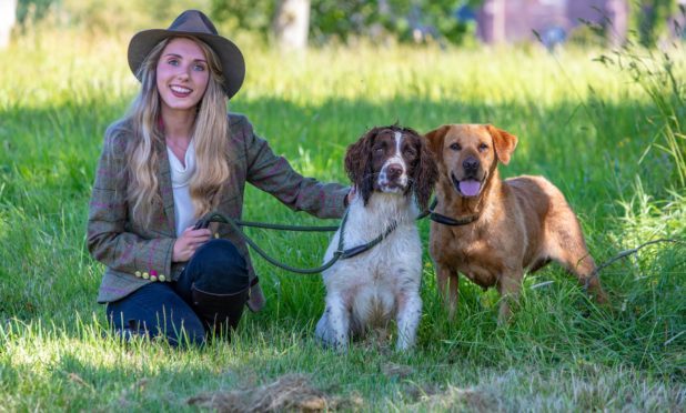 Rachael Griffin (24) from Glasgow with gun dogs Wolf the Springer Spaniel and Nala the Red Labrador.