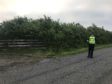 A police officer maintains a cordon outside the reservoir