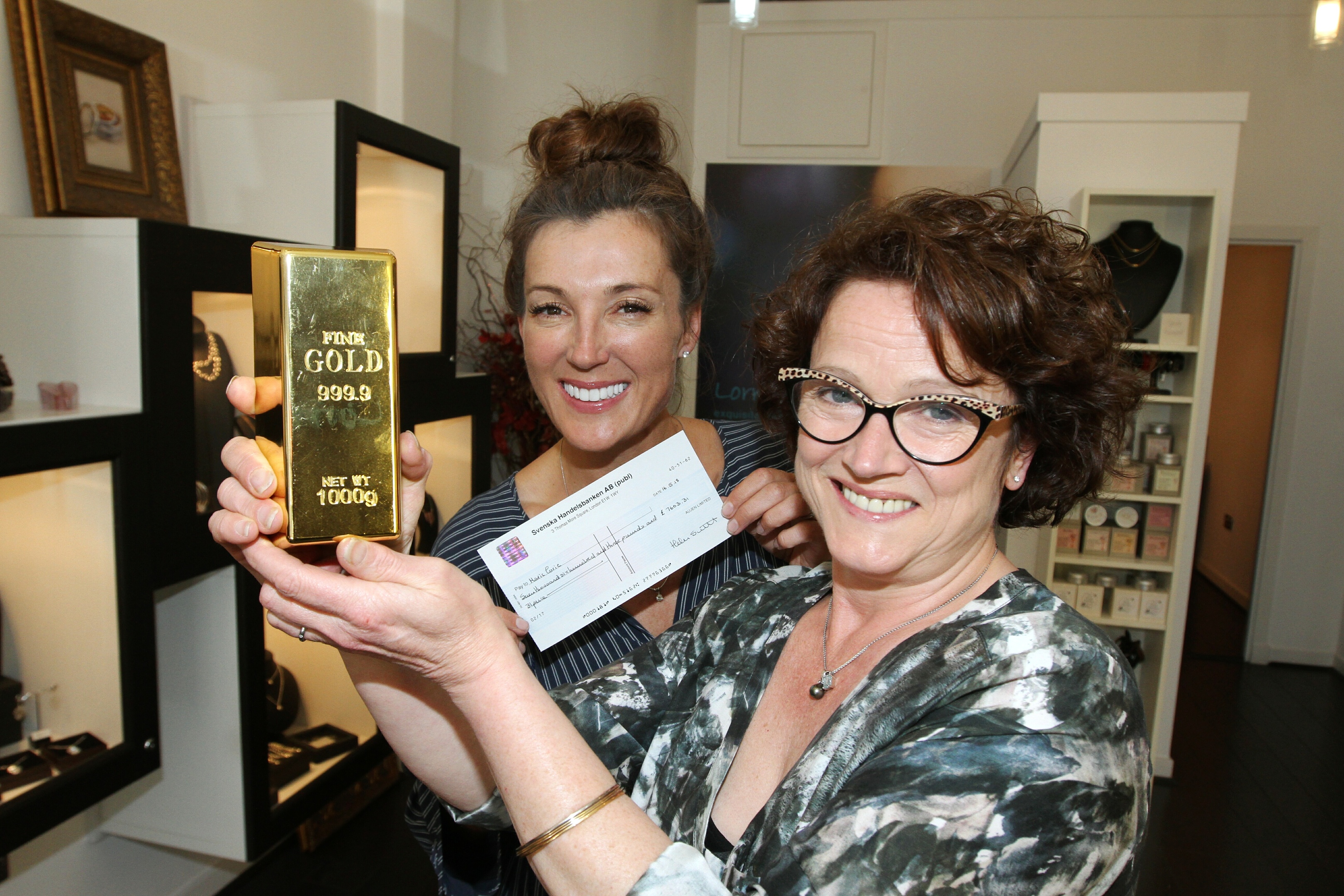 Lorraine Law presented  Marie Curie patron Petra McMilllan with a gold ingot worth £7,603.31, proceeds from the jewellery donated to be melted down.