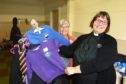 Rev Maggie Hunt & volunteer Helen McLeod are pictured with some of the clothes