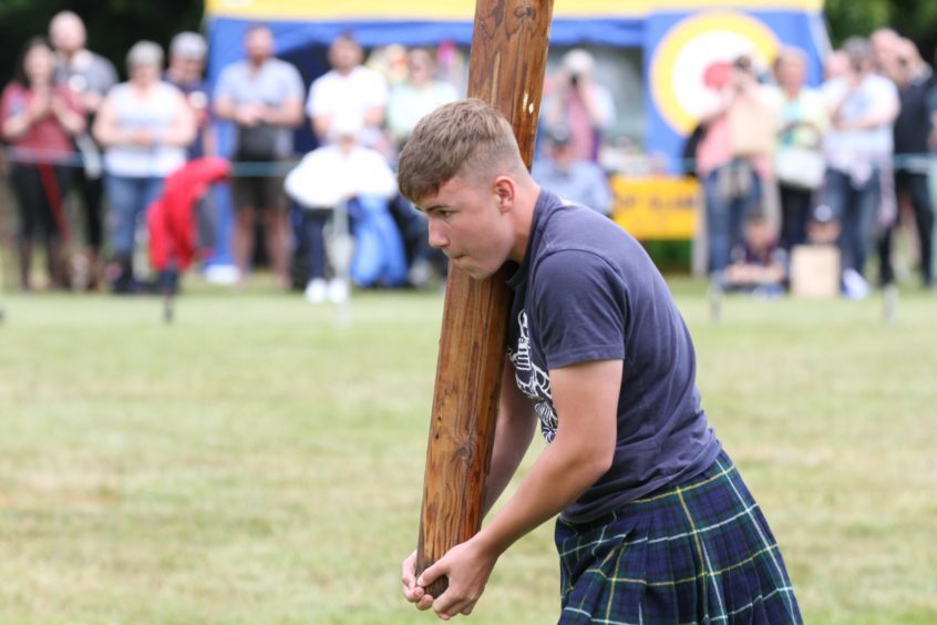 16 year old Christian Ramsay from Alyth tossing the caber