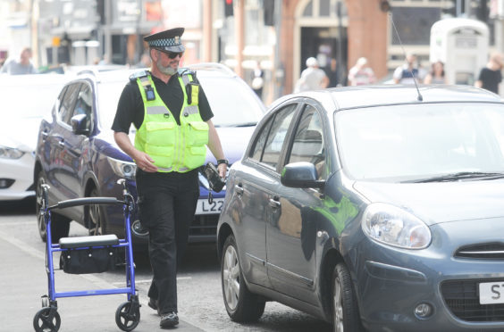 A parking attendant at work in South Street, Perth