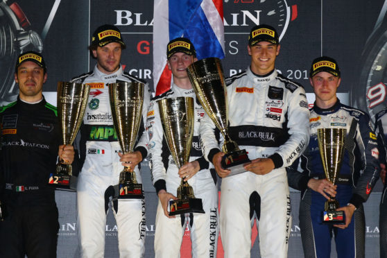 Sandy Mitchell (centre) on top of the Paul Ricard podium with teammates Michele Beretta and Martin Kodric