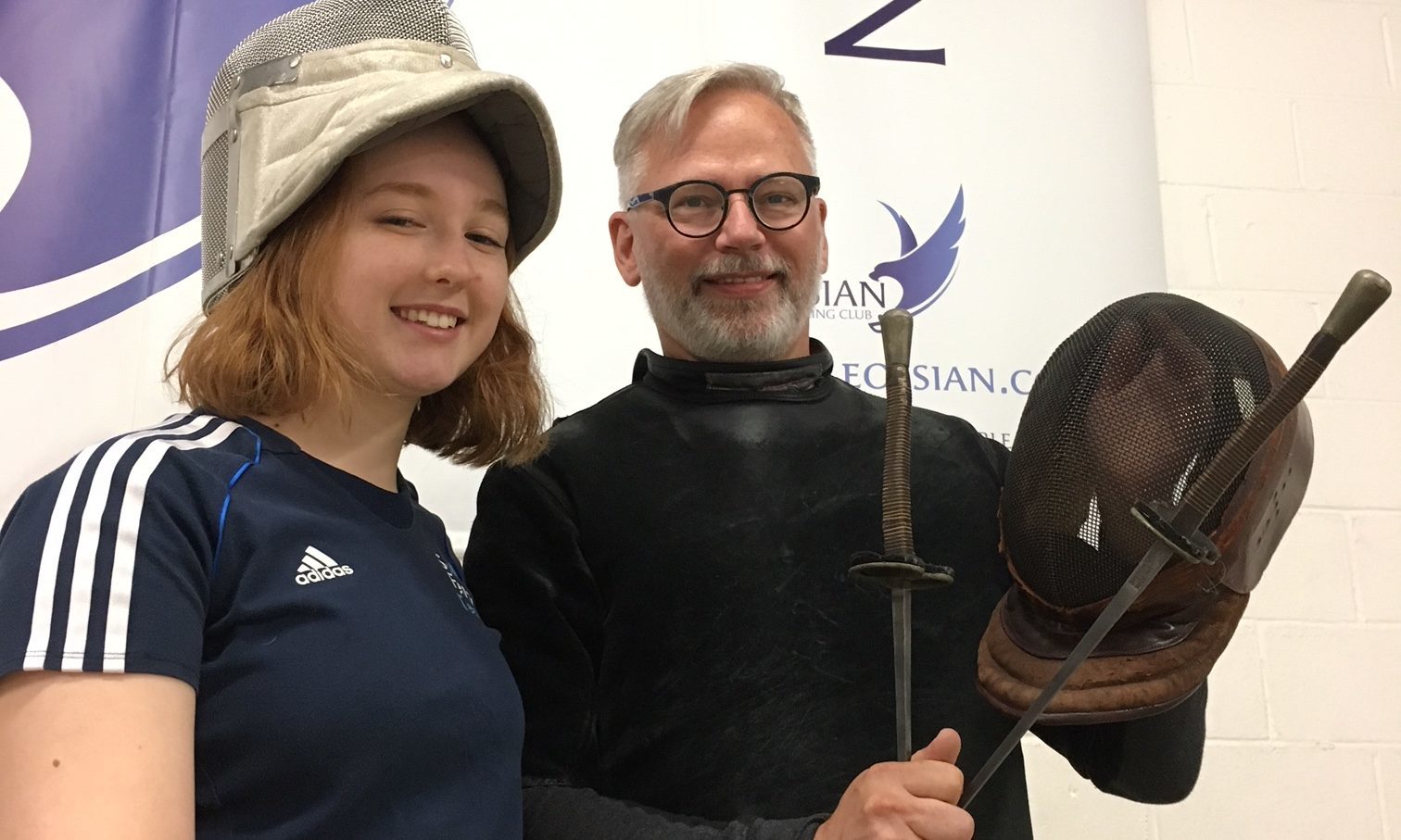 Salle Ossian fencer Katie Daykin and coach Phil Carson show off the historic Wilkinsons Sword mask and foils which will be up for auction at a Live at Loft fundraiser later this month.