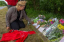 James Morrison's cousin Jamie Lee places some of the tribute messages by his friends near the place where he was killed