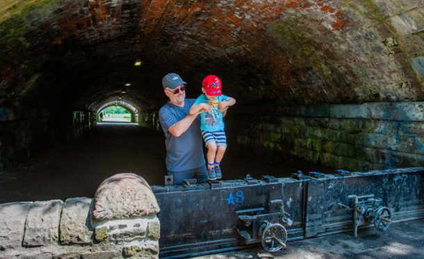 Llocal resident Willie White and grandson Adam White (aged 3 ) trying to get across the flood defence barrier. at the South Inch underpass.