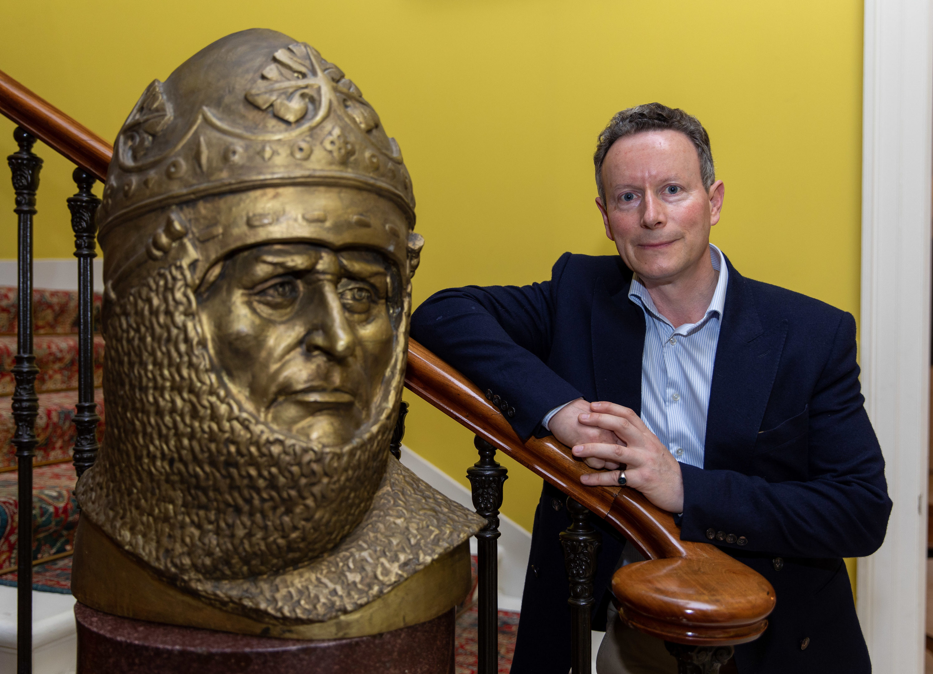 Lord Bruce pictured with a bust of his ancestor King Robert the Bruce at Broomhall in Fife