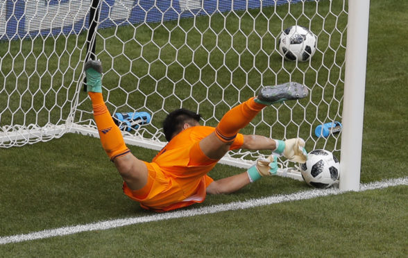 Eiji Kawashima lets a free-kick in at his near post.