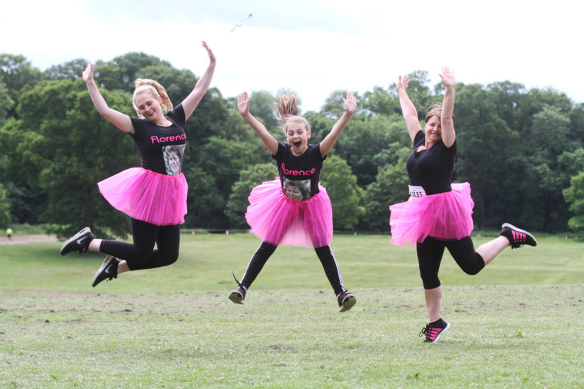 Rachael Adams, 24, Louise Essey, 13, and Susan Martin, 56, from the West End doing the pretty muddy 5k