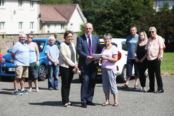 Councillor Beth Pover (left), Perthshire North MSP John Swinney and resident Hilda Edmonds  with more concerned villagers.