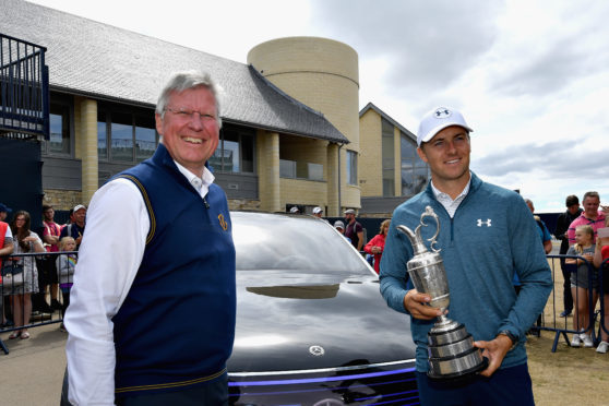 Jordan Spieth rpepares to relinquish the Caret Jug back into the care of Martin Slumbers at Carnoustie yesterday.