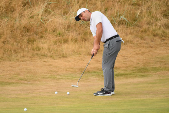 Francesco Molinari of Italy putts on the first hole during previews to the 147th Open Championship at Carnoustie Golf Club.