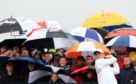 Rory McIlroy framed by the umbrellas during the morning rain in the second round at Carnoustie.