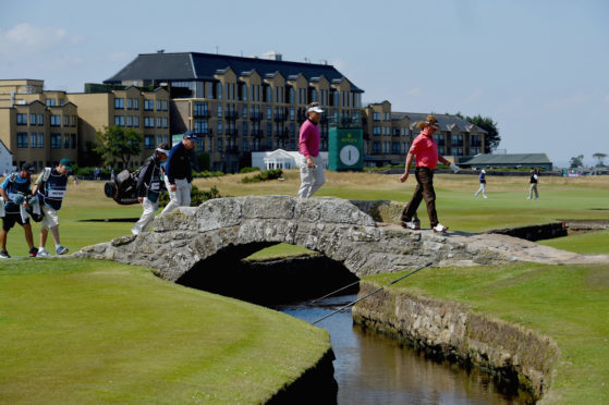 Tom Watson, Bernhard Langer and Miguel Angel Jimenez cross the Swilcan Bridge during the Senior Open.