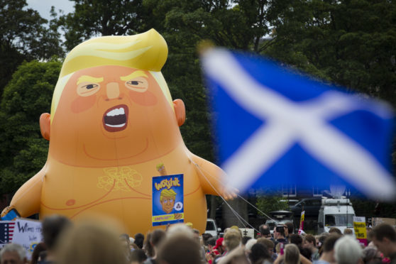 Protesters rallying against Donald Trump's Scotland visit march from Holyrood to the Meadows.