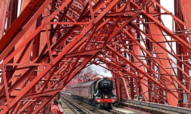 Craig & Rose supplied the iconic red paint for the Forth Rail Bridge for more than a century. Picture shows The Flying Scotsman steaming across the span earlier this year.