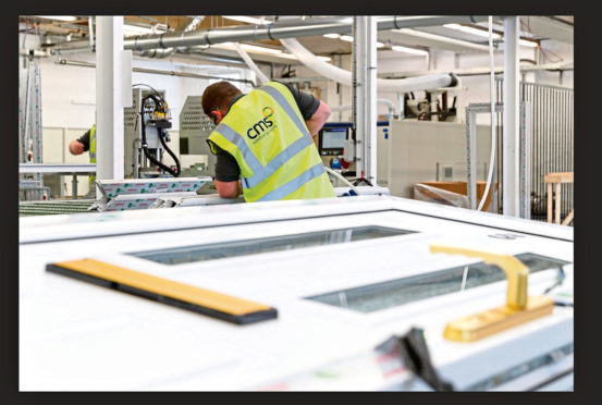 A worker at CMS Window Systems' factory in Kirkcaldy.