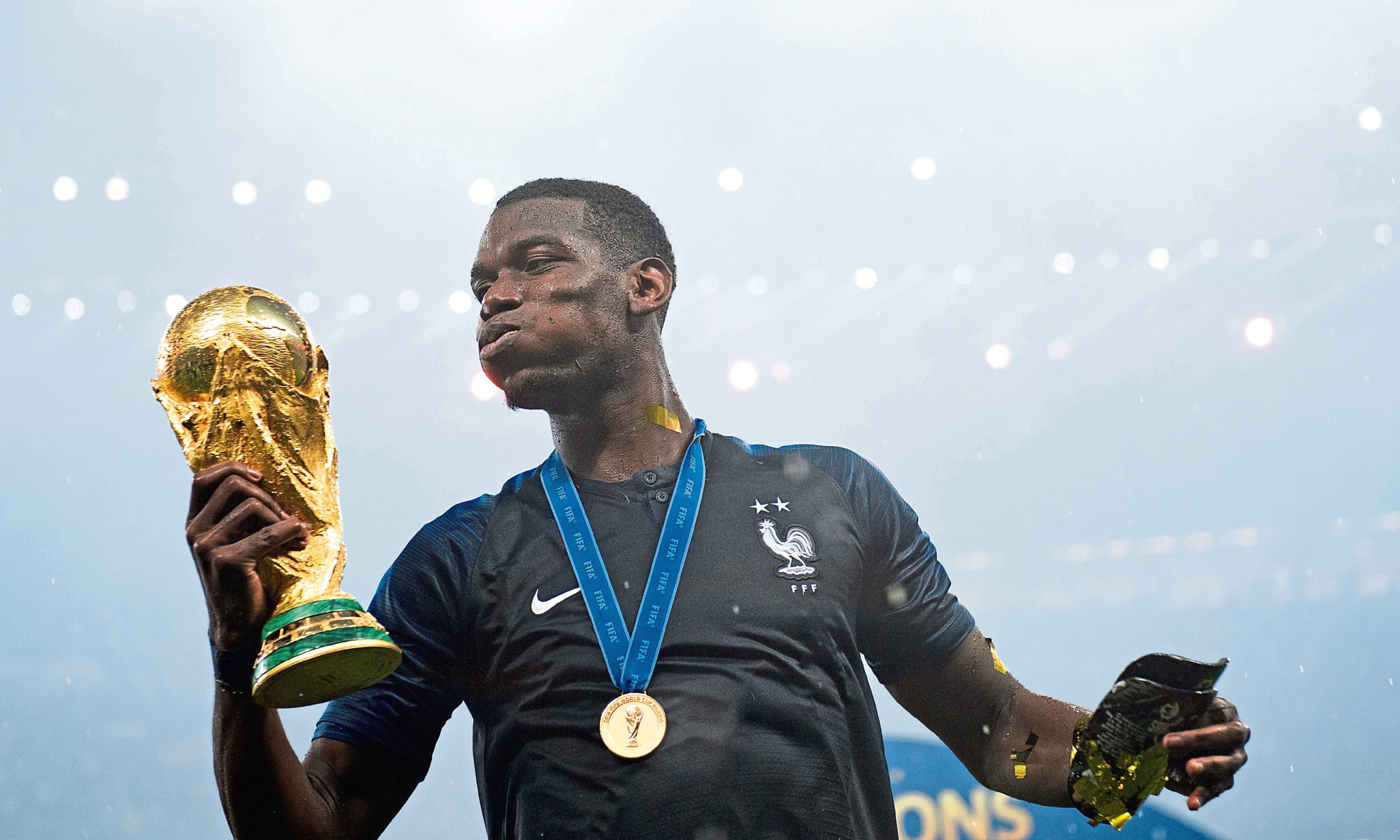French midfielder Paul Pogba with the World Cup. The football tournament has been credited with an increase in retail spending.