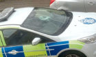 Damaged windscreen on a police car on the hilltown near to the police station