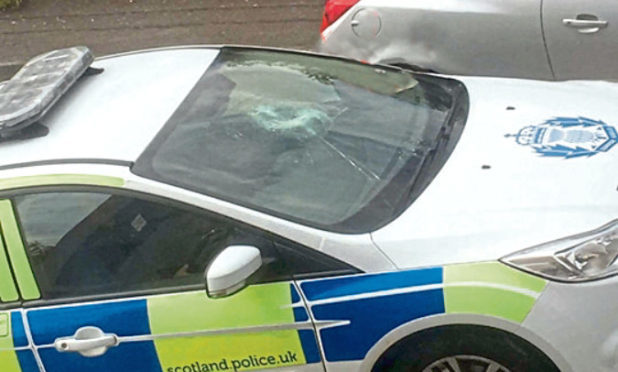 Damaged windscreen on a police car on the hilltown near to the police station