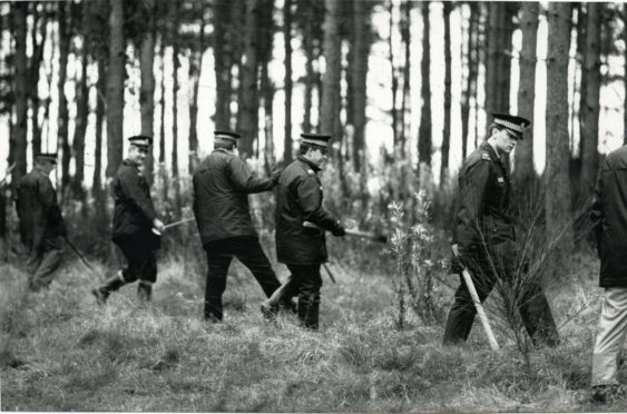 Police search woodland in Fife during the search for Mrs Hunter.