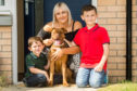 Clare Smith with her sons Flynn, 4, and Kiernan, 9, and Nala.