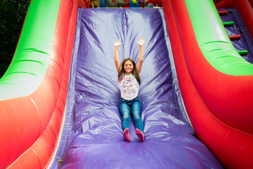 Nine year old Taylor Dylan from Kennoway enjoys the inflatable slide.
