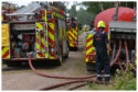 Firefighters tackle the blaze at the Red Squirrel Trail at Devilla Forest near Kincardine on Tuesday.