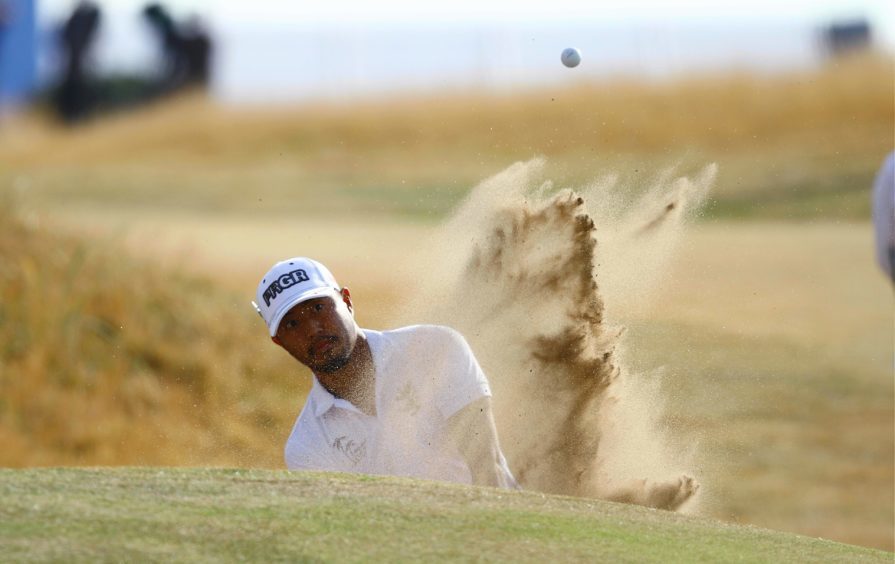 Satoshi Kodaira from Japan, blasts out of a bunker of the first.