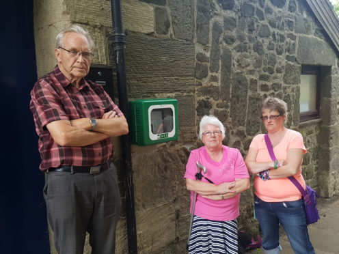 Chairman Ron Page and community council members Mary and Denise Wallace are appealing for help in tracing the stolen device.