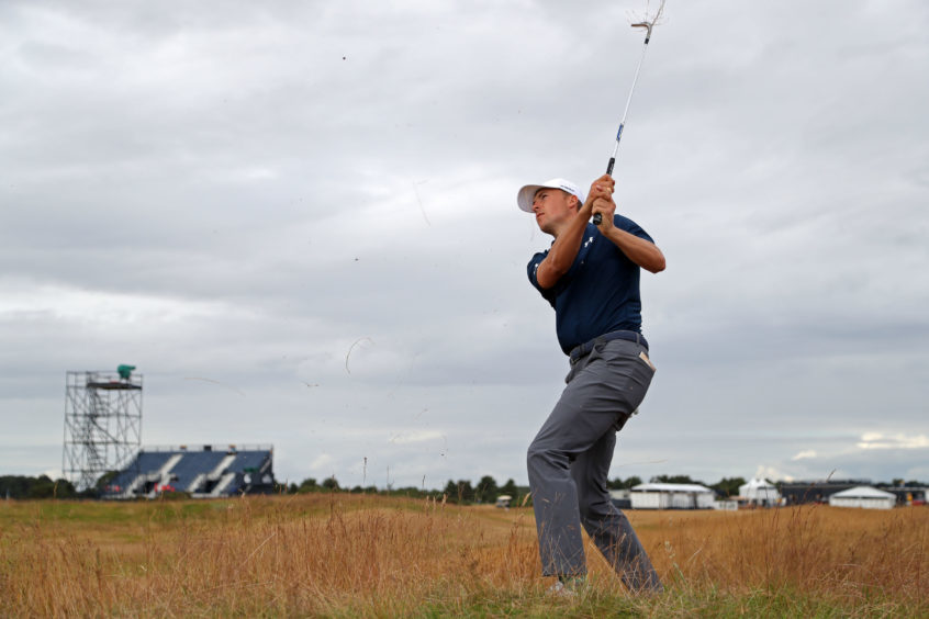 Freshly shorn Jordan Spieth chips from the rough during day three.