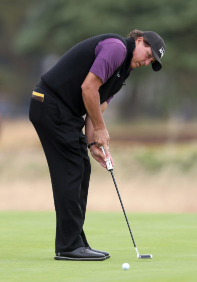 USA's Phil Mickelson putts during preview day three of The Open .