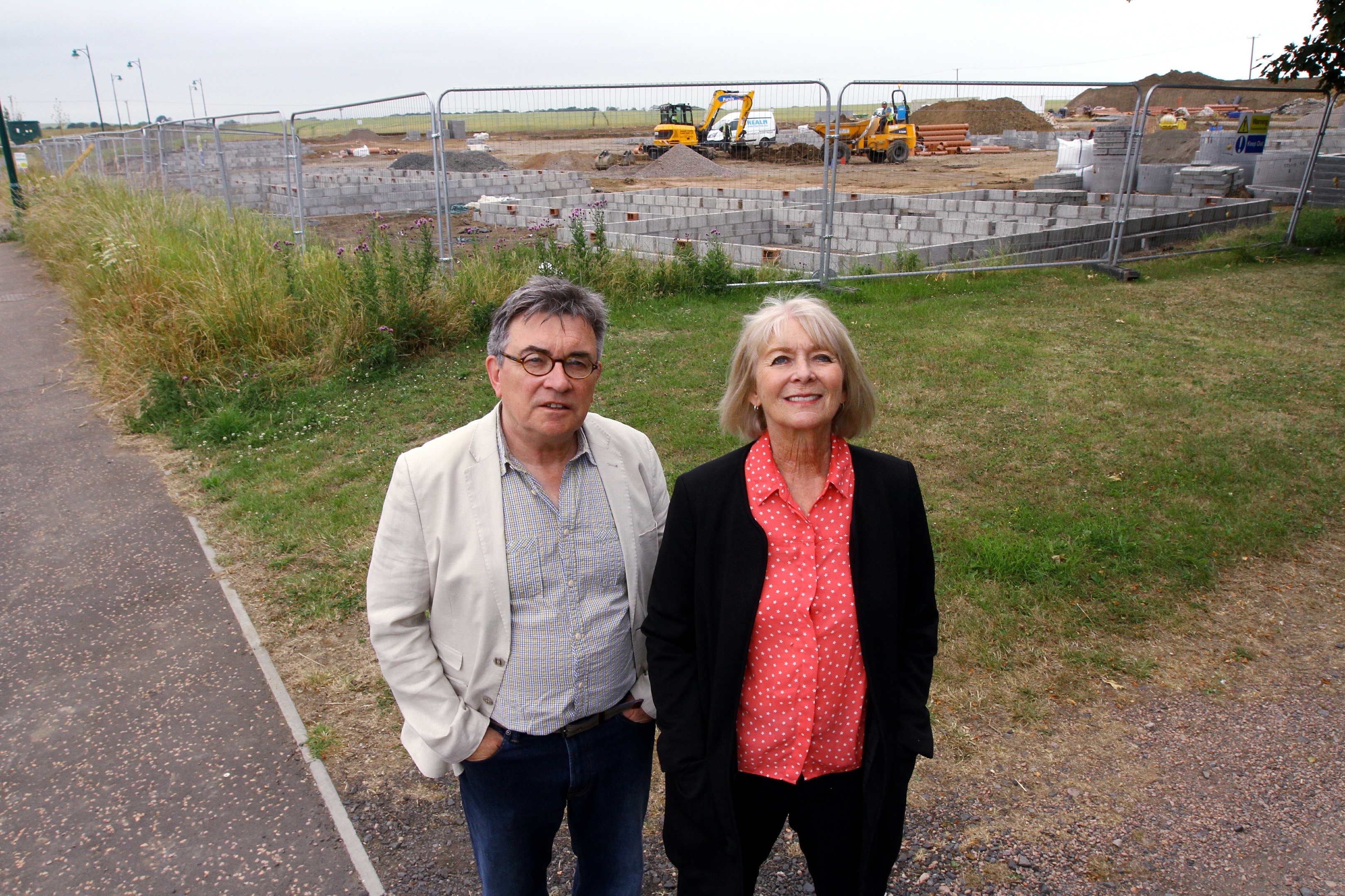 Local residents Kate Holy and Martin Dibbs at the site for the new housing in Station Road,
Kingsbarns.