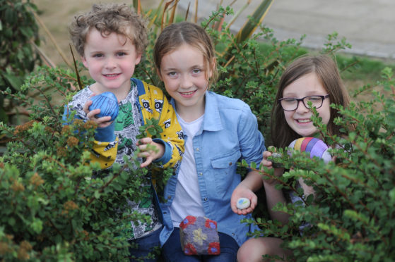 Max Park (4), Olly Learmonth (10), and  Evie Henderson (9), hiding stones in the Rainbow Park in the Mid Links, Montrose.