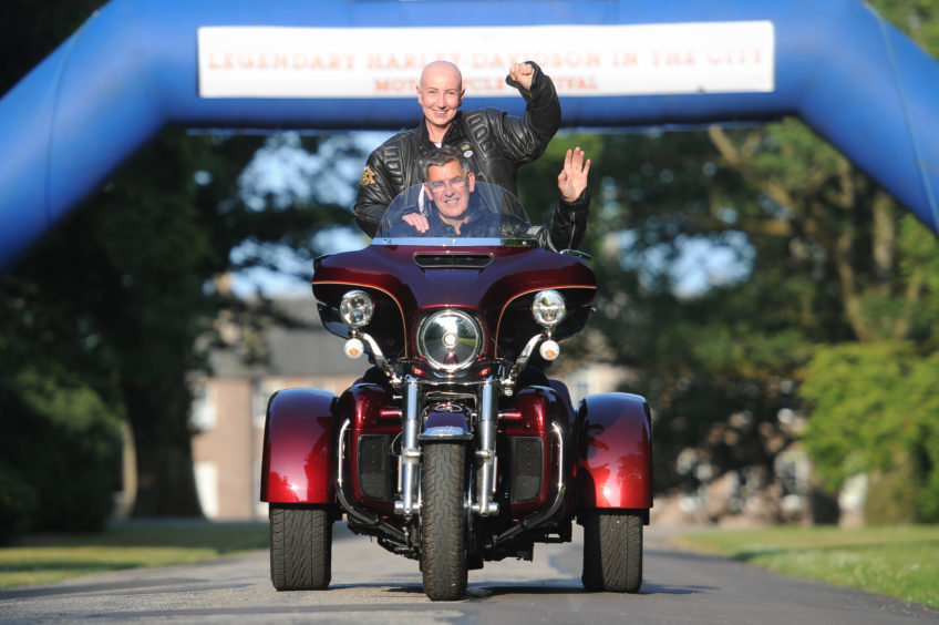 Carla Assenti riding pillion with Dave Scott at Brechin Castle.