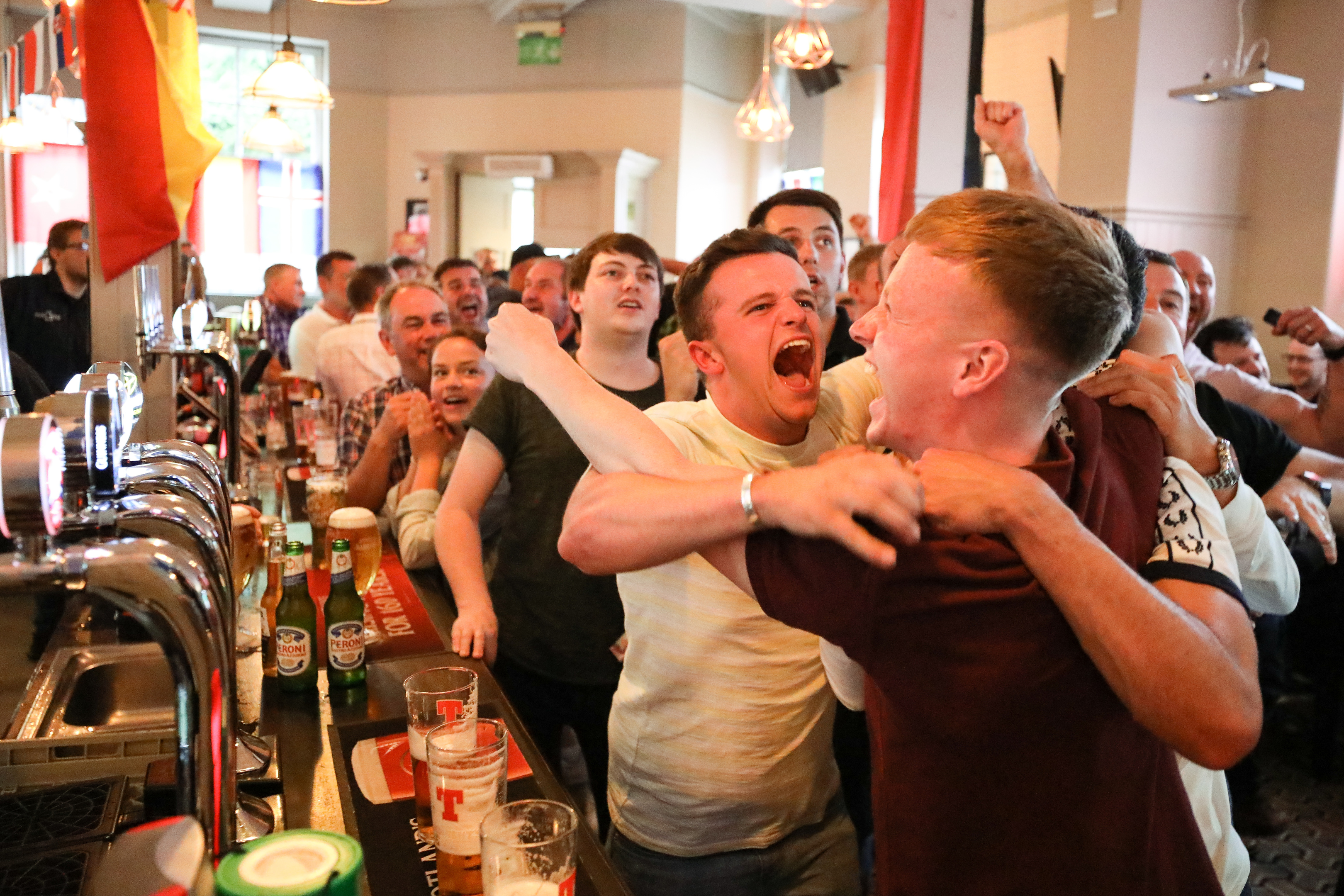 Fans celebrating a Croatia goal in Post Office Bar, Dundee.
