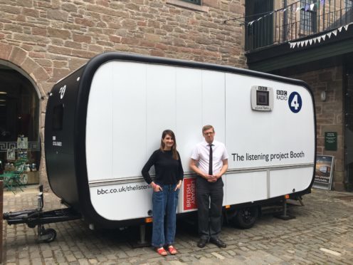 Producer Victoria McArthur with operator Mark Thompson in front of the Listening Project trailer.