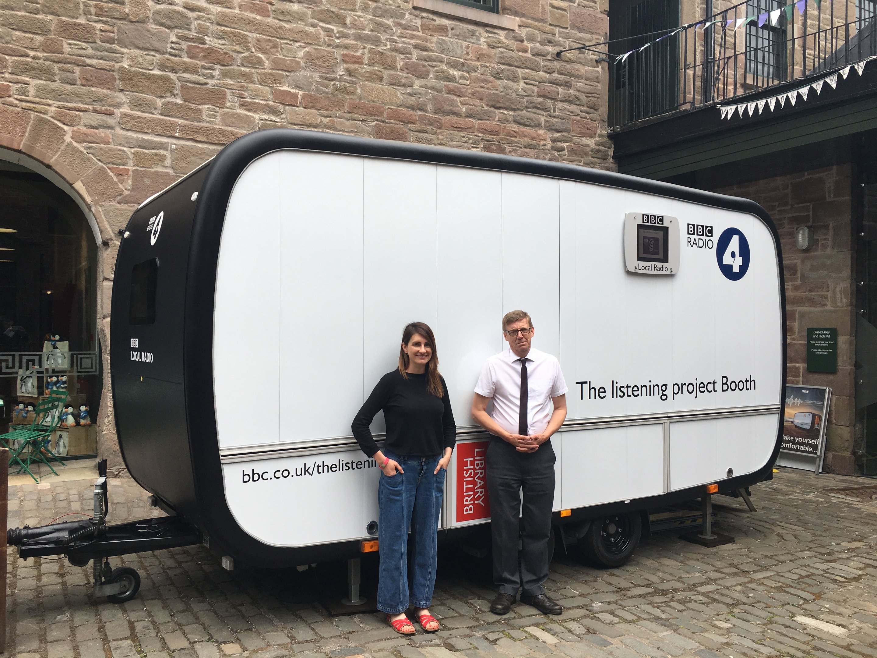 Producer Victoria McArthur with operator Mark Thompson in front of the Listening Project trailer.