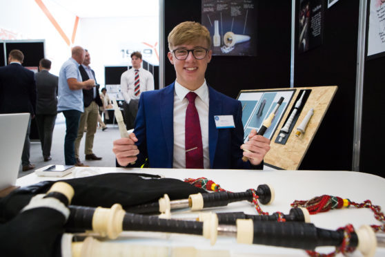 Robbie MacIsaac with his invention and bagpipes.