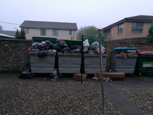 Overflowing bins in Rockwell Place.