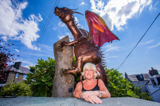 Fiona Philp with the dragon in the background.