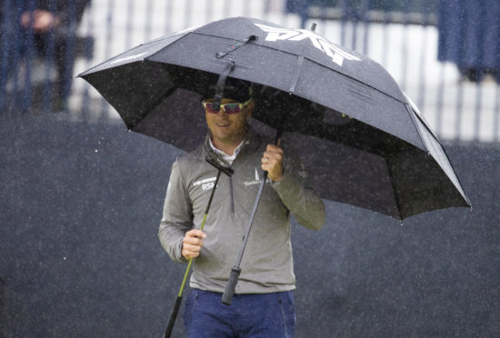 Zach Johnson came through the rain to share the lead at the Open at Carnoustie.