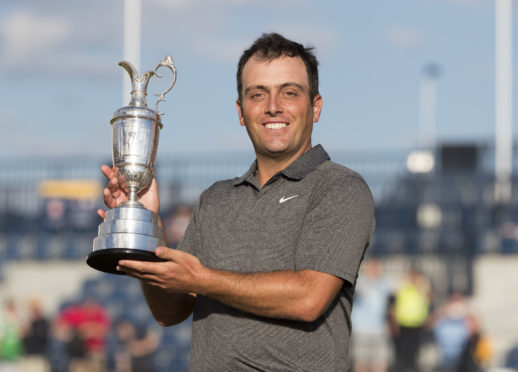 Italy's Francesco Molinari celebrates his win with the Claret Jug.