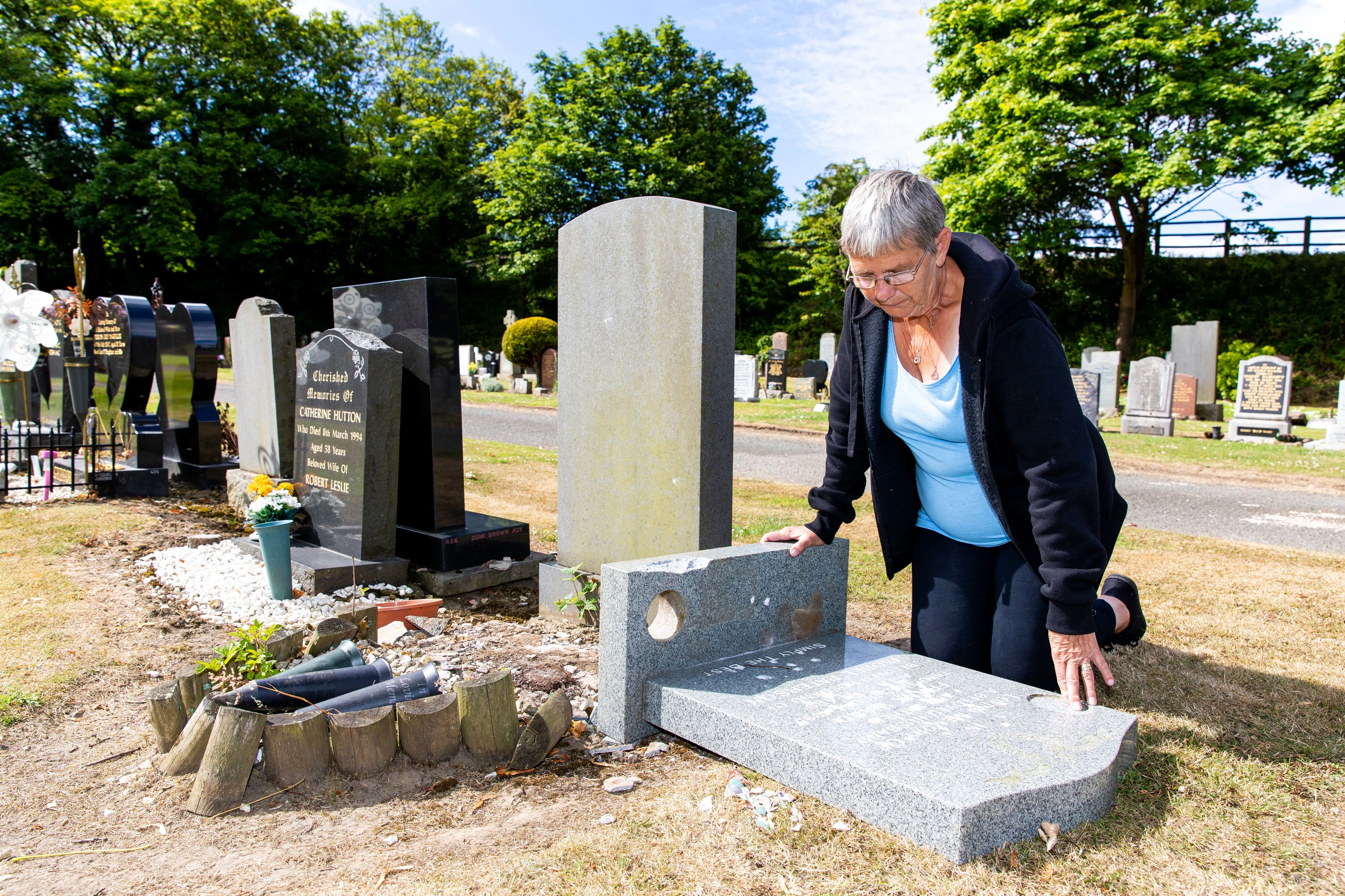 Courier News - Fife - Sarah Vesty - Graves Vandelism in at cemetary - CR0002372 - Inverkeithing - Picture Shows: Isobel Ward (67) from Inverkeithing is hurt & disgusted in what appears a targetted attach on the grave stone of her late husband and a memorial plaque in seperate section of cemetary - Thursday 5th July 2018